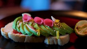 avo toast, sriracha, watermelon radish, finger lime, toasted seeds. avocado sandwich Man preparing delicious avocado toast. Hands spread mashed avocado on toasted rye bread. Overhead shot - Powered by Shutterstock - Get 15% off with code: PIKWIZARD15