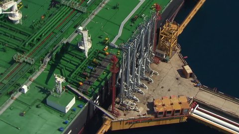 Aerial helicopter shot of a tanker with its mechanization in LNG terminal