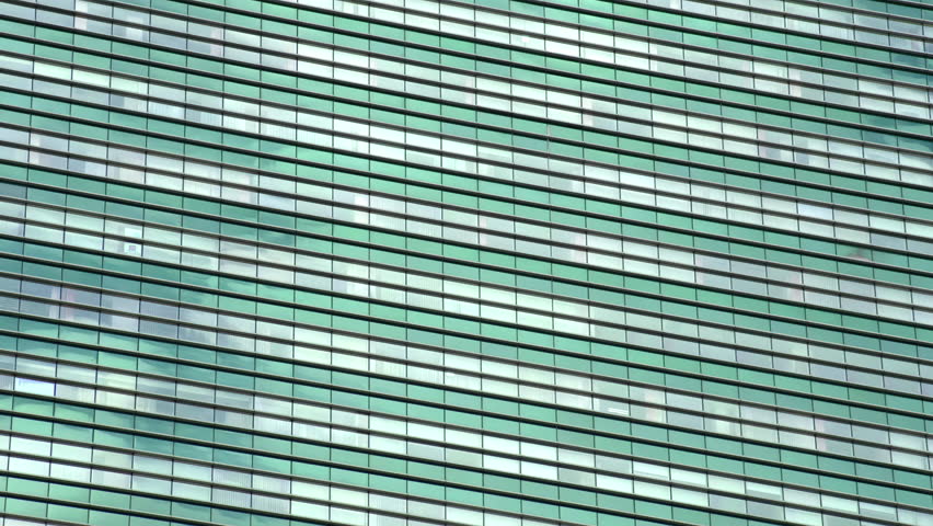 Sky Reflection in Glasses. Quickly running clouds reflected in the windows of a skyscraper. Time lapse