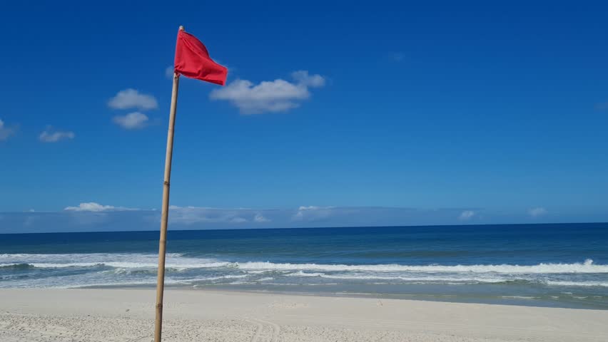 Red Flag at beach.  It means pay close attention when swimming in the sea.  Praia Seca, Brazil.