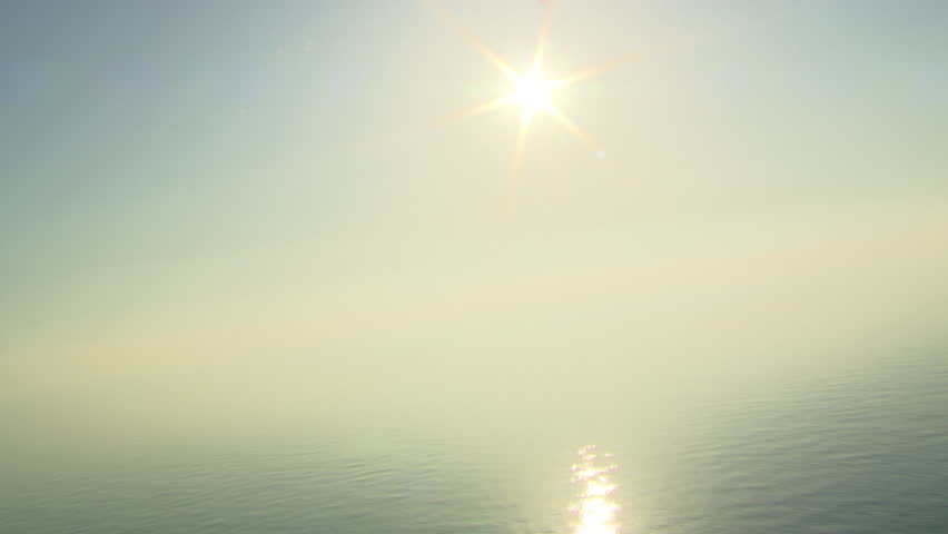 Sun reflecting off of the Adriatic sea. Aerial helicopter shot.