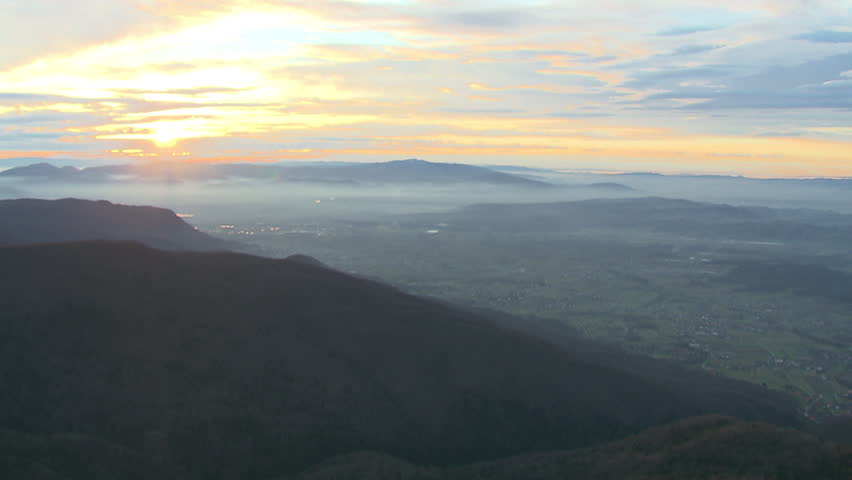 Aerial helicopter shot of a beautiful sunrise over mountain Medvednica and green