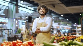 Portrait salesman male worker in supermarket looking at camera and smiling. Handsome man employee staff in apron in grocery store Happy Positive greengrocer small business owner shopkeeper in market  - Powered by Shutterstock - Get 15% off with code: PIKWIZARD15