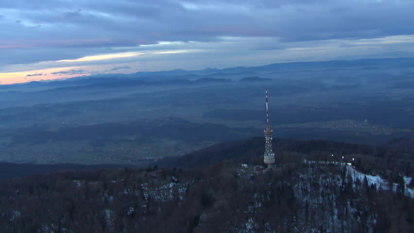 Aerial shot of ski track and TV tower on the top of the peak Sljeme at dusk