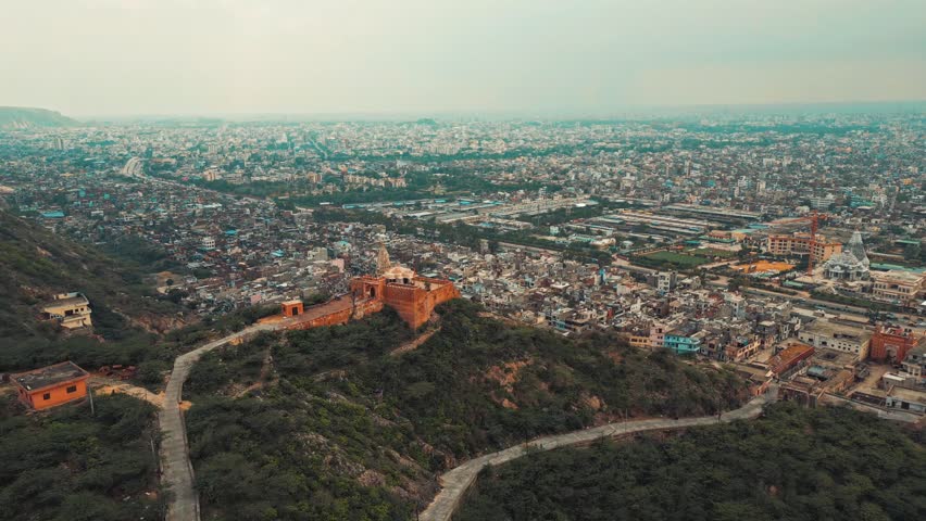 A grand Rajasthani fort stands tall, its intricate architecture and surrounding landscapes capturing timeless beauty