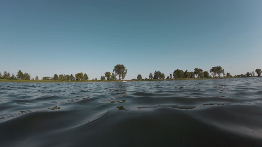 Funny middle-aged man jumping into water. Guy dives into cold refreshing lake on hot summer day. Relaxation, energetic way of life, enjoying life, adventures.