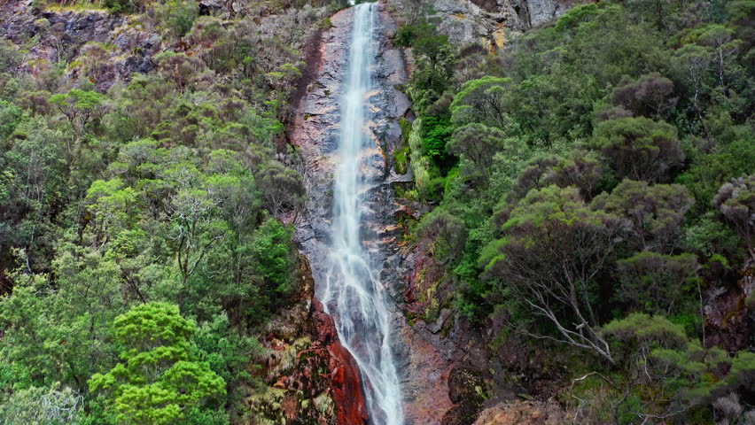Amazing nature of Tasmania Australia. Waterfall drops from high mountain cliff