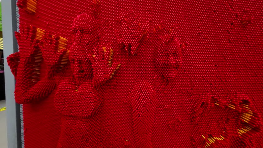 Three d board for pin art.Man makes cloned print in red panel.Tactile Senses and Sensations Device. Three d cloning panel. Learning and Science.Fun Experiments with Tactile Sensitivity.4k footage