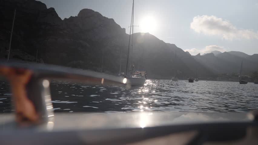 Low angle shot of a yacht sailing slowly into the Nice port during summer