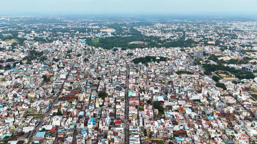 Expansive aerial view of a densely populated residential area in Mysuru, India, highlighting compact housing, vibrant neighborhoods, and the intricate layout of urban life in a bustling Indian city.