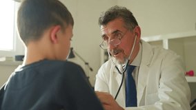 Doctor in a white coat conducts a health consultation with a child, using a stethoscope and maintaining a caring and professional demeanor. Concept of healthcare, pediatrics, and trust - Powered by Shutterstock - Get 15% off with code: PIKWIZARD15