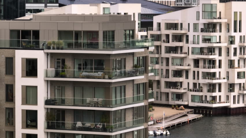 Telephoto drone shot circling riverside, luxury condos in Copenhagen, Denmark