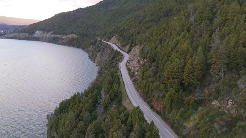 Aerial view of Siete Lagos Route 40 crossing Lácar lake and pine mountains in San Martín de Los Andes, Neuquén, Patagonia Argentina