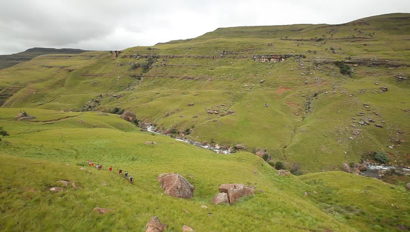 A wide shot of people hiking in the  lush green hills of  KwaZulu-natal  .