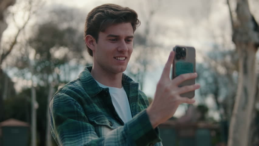Young man taking photo on mobile phone