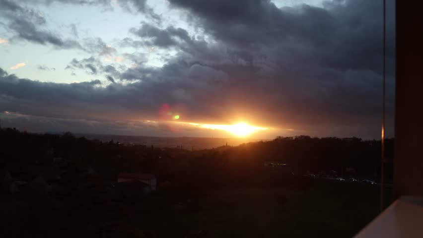 sunset and dark clouds, forest is slightly visible