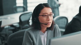 Japanese woman, customer service and conversation with web help, tech and crm support with telemarketing at desk. Sales consultant, online and worker with feedback, call center and headphones for job - Powered by Shutterstock - Get 15% off with code: PIKWIZARD15