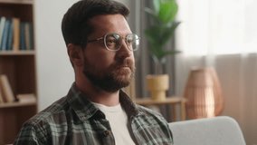 Portrait at home calm serious bearded man guy male homeowner at home apartment loan mortgage credit insurance indoor relax on couch sofa looking at camera wearing eyeglasses bad vision health medicine - Powered by Shutterstock - Get 15% off with code: PIKWIZARD15