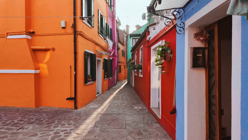 Revealing a street with colorful and traditional houses in the island of Burano, Venice, Italy. Venice is an archipelago of 126 islands separated by canals linked by 472 bridges