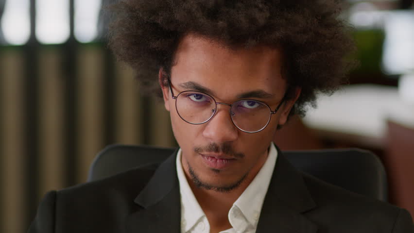Close up portrait African American man male businessman business guy leader employer entrepreneur manager in office confident serious looking at camera authority masculine worker face expression angry