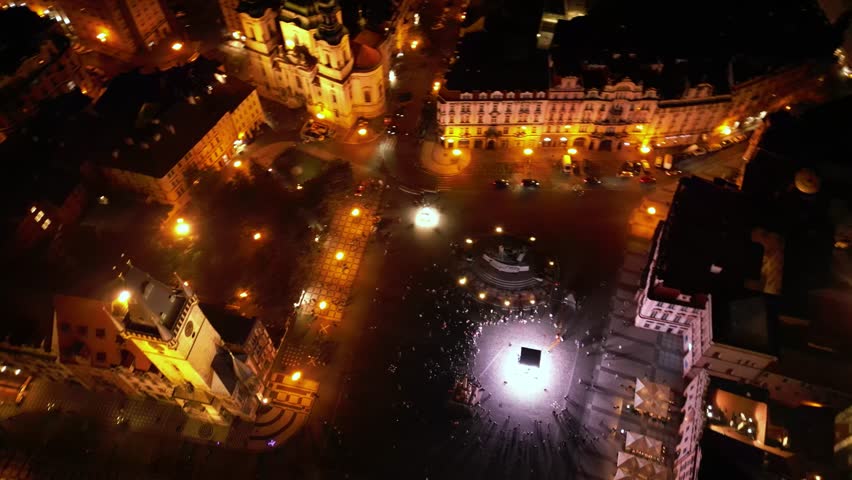Aerial night footage of the old city center of Prague, Czech Republic. Bohemia capital Praha seen from above. Old town square, the Prague Astronomical Clock and Tyn Church seen in the evening light.