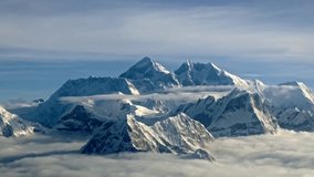 Mount Everest, the 'Roof of the World,' rises above clouds in Nepal, its snow-capped peaks gleaming under the sun, showcasing the awe-inspiring beauty of the Himalayan range. - Powered by Shutterstock - Get 15% off with code: PIKWIZARD15