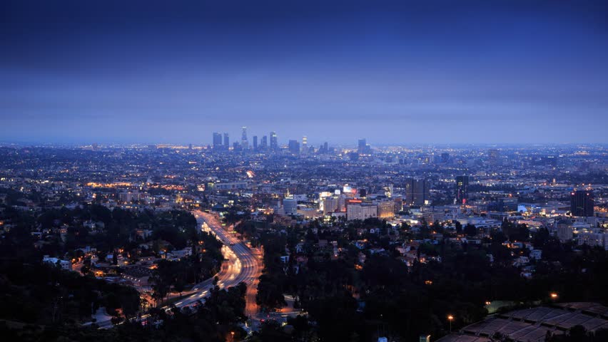 Los Angeles city timelapse. Transition from dusk to night. View from Hollywood Hills on freeway 101 and downtown LA.