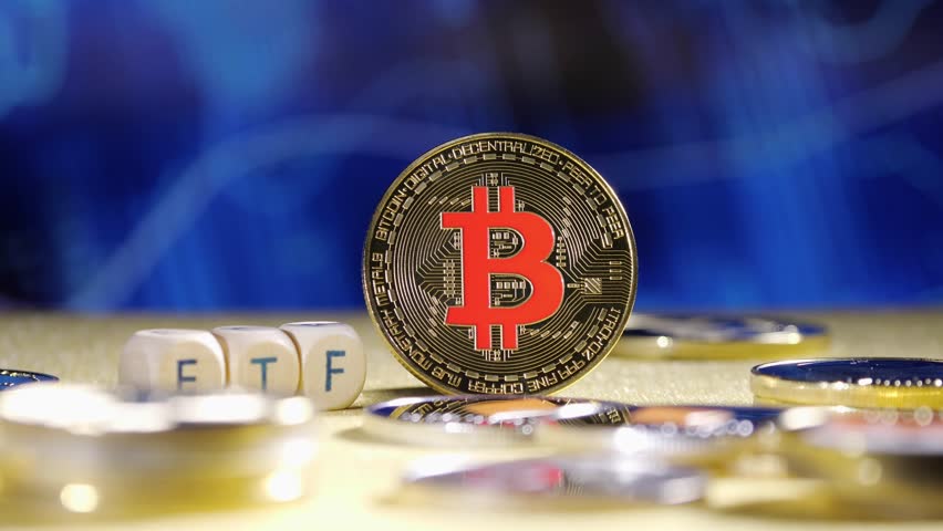 Bitcoin ETF. coin stands against a blurred blue background with financial graphs. Other coins are scattered around it. The image conveys a modern approach to finance and investment on stock marketa