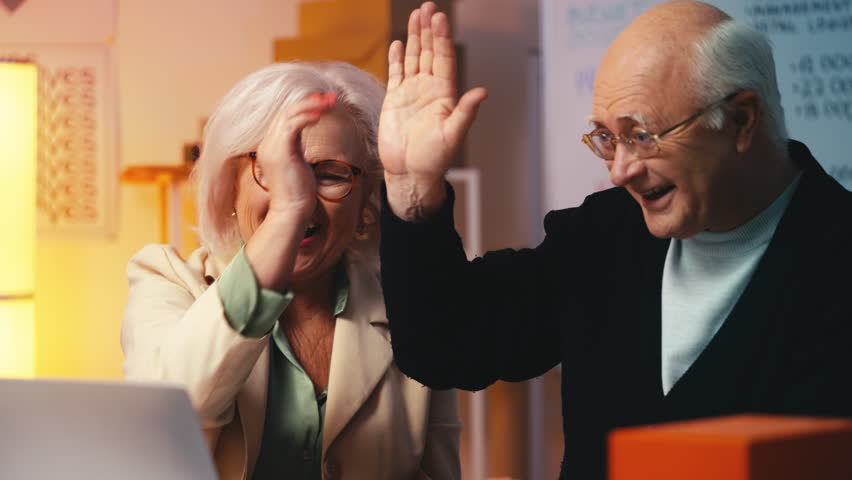 Senior business people receiving large online order, giving a high five, success - Powered by Shutterstock - Get 15% off with code: PIKWIZARD15