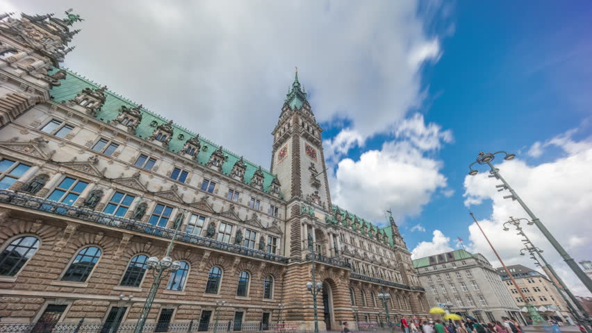 Building of the Hamburg City Hall timelapse hyperlapse, the seat of the government of Hamburg, located in the Altstadt quarter in the city center. Front view from the main square under a cloudy sky