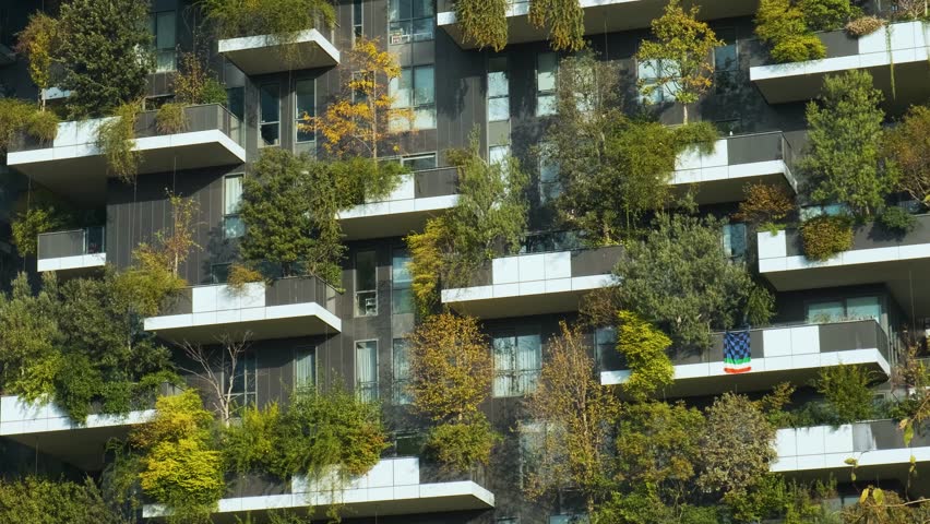 Vertical forest building with lush greenery and trees integrated into modern architecture, Milan, Italy. Vertical garden and landscaping, innovative architecture, urban sustainability