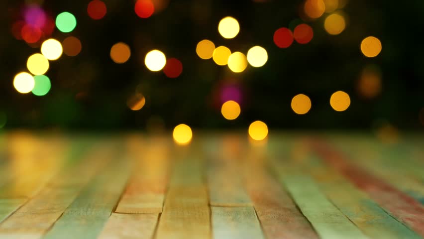 Festive background with colorful lights and table top. Space for text