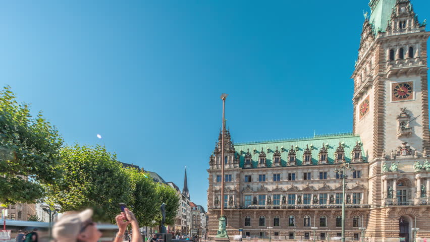 Panorama showing a building of the Hamburg City Hall timelapse, the seat of the government of Hamburg, located in the Altstadt quarter in the city center. View from the main square at sunny day