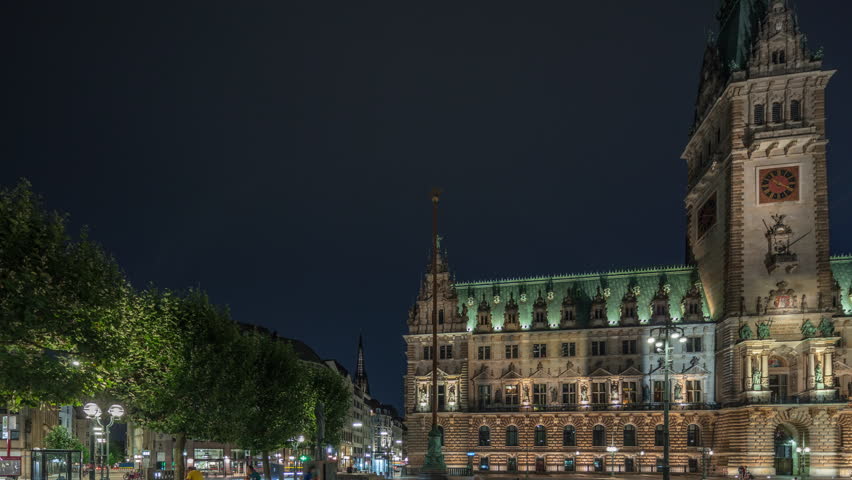 Panorama showing illuminated building of the Hamburg City Hall night timelapse, the seat of the government of Hamburg, in the Altstadt quarter in the city center. Front view from the main square