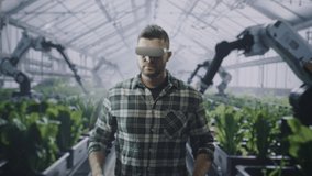 Modern Farmer Using Vr Headset In Greenhouse Controlling Robotic Arms Future Agriculture Technology Innovation Automation - Powered by Shutterstock - Get 15% off with code: PIKWIZARD15