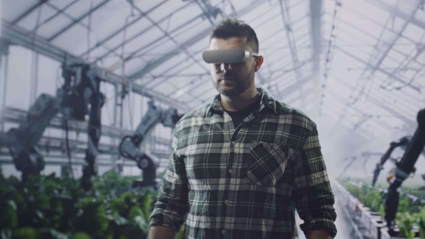 Agricultural Engineer Using Virtual Reality Headset In Modern Greenhouse With Robotic Arms Technology Innovation Smart Farming Future - Powered by Shutterstock - Get 15% off with code: PIKWIZARD15