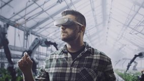 Modern Farmer Using Virtual Reality Headset In Smart Greenhouse With Robotic Arms Future Agriculture Technology Innovation Automation - Powered by Shutterstock - Get 15% off with code: PIKWIZARD15