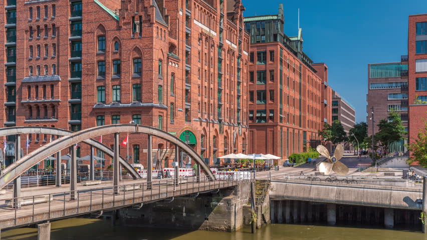 Famous old Speicherstadt in Hamburg timelapse featuring the International Maritime Museum, iconic brick buildings, arch bridges, canals and waterfront. A historic landmark in Germany