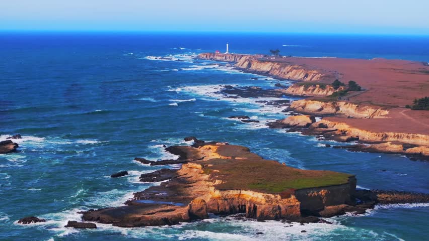 Point Arena Lighthouse islands Racas Sea Lion Rocks Cove California aerial drone Stornetta coastal Trail Mendocino coast vista point sunny daytime morning afternoon blue sky waves autumn backwards