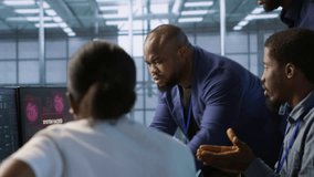 Cybersecurity specialists in server room trying to protect equipment from hacker stealing data. Programmers in data center office doing teamwork to delete virus attacking company servers, camera A - Powered by Shutterstock - Get 15% off with code: PIKWIZARD15