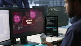 Programmer seeing red critical error popup on computer display in data center, panicking. African american man in server hub spamming keyboard buttons after receiving error, camera A - Powered by Shutterstock - Get 15% off with code: PIKWIZARD15