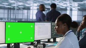 Software developer in server farm ensuring data remains shielded from potential threats using mockup PC. IT expert safeguarding data center against hackers with green screen computer, camera A - Powered by Shutterstock - Get 15% off with code: PIKWIZARD15