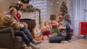 Multiracial lovely family celebrating Christmas party together in house. Adorable young children and relatives spending leisure time celebrate holiday Thanksgiving, xmas eve in living room at home. - Powered by Shutterstock - Get 15% off with code: PIKWIZARD15