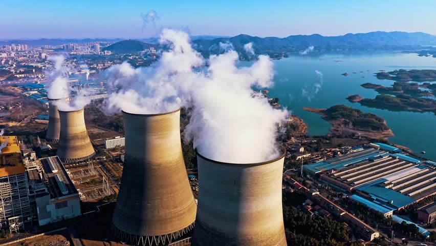 Aerial view of chimneys of power plant, an industrial district. Modern large thermal power plant