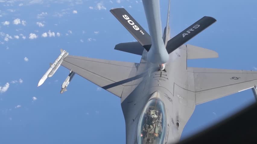 U.S. Air Force F-16 Fighting Falcons assigned to the 77th Expeditionary Fighter Squadron conduct aerial refueling with a KC-135 Stratotanker over the Pacific Ocean.