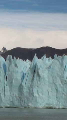 Explore the stunning ice formations of the Patagonia Andes, where towering glaciers rise majestically against the backdrop of rugged mountains, showcasing nature