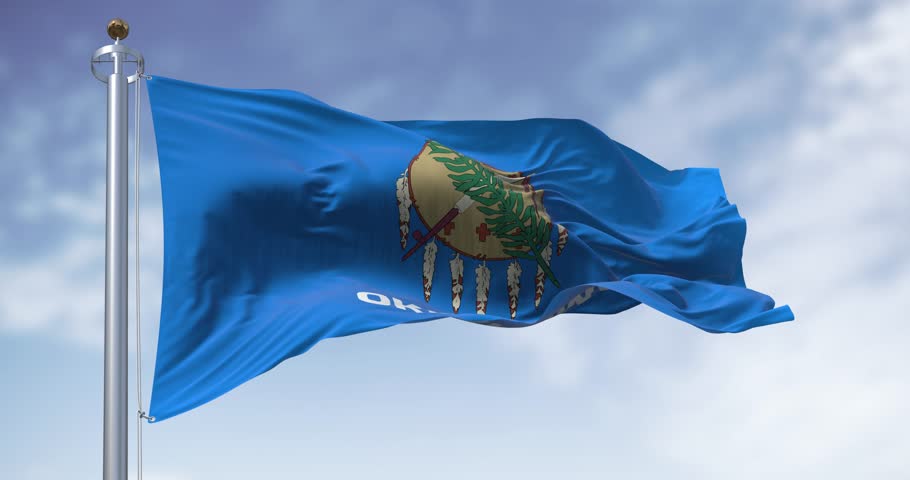 The Oklahoma state flag waving on a clear day. Oklahoma is a state in the South Central region of the United States. Seamless 3d render animation. Slow motion loop. Selective focus