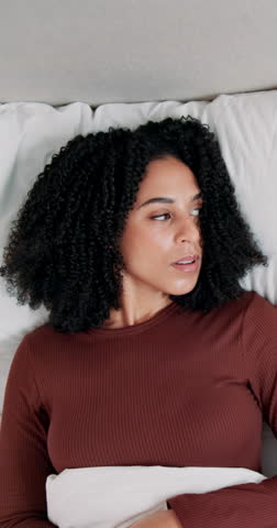 Frustrated woman, ears or bed with pillow for snoring, loud or bad noise above at home. Top view, angry or female person lying with irritation, sound or fatigue for insomnia or sleep apnea in bedroom