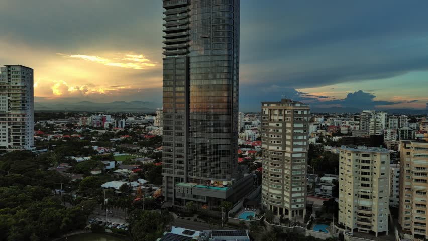 Anacaona 27 tower skyscraper and cityscape. Santo Domingo in Dominican Republic. Aerial backward