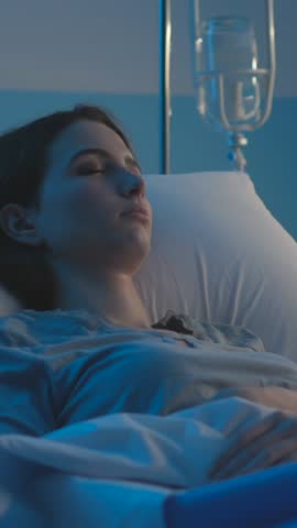 Worried patient lying in bed at the hospital at night